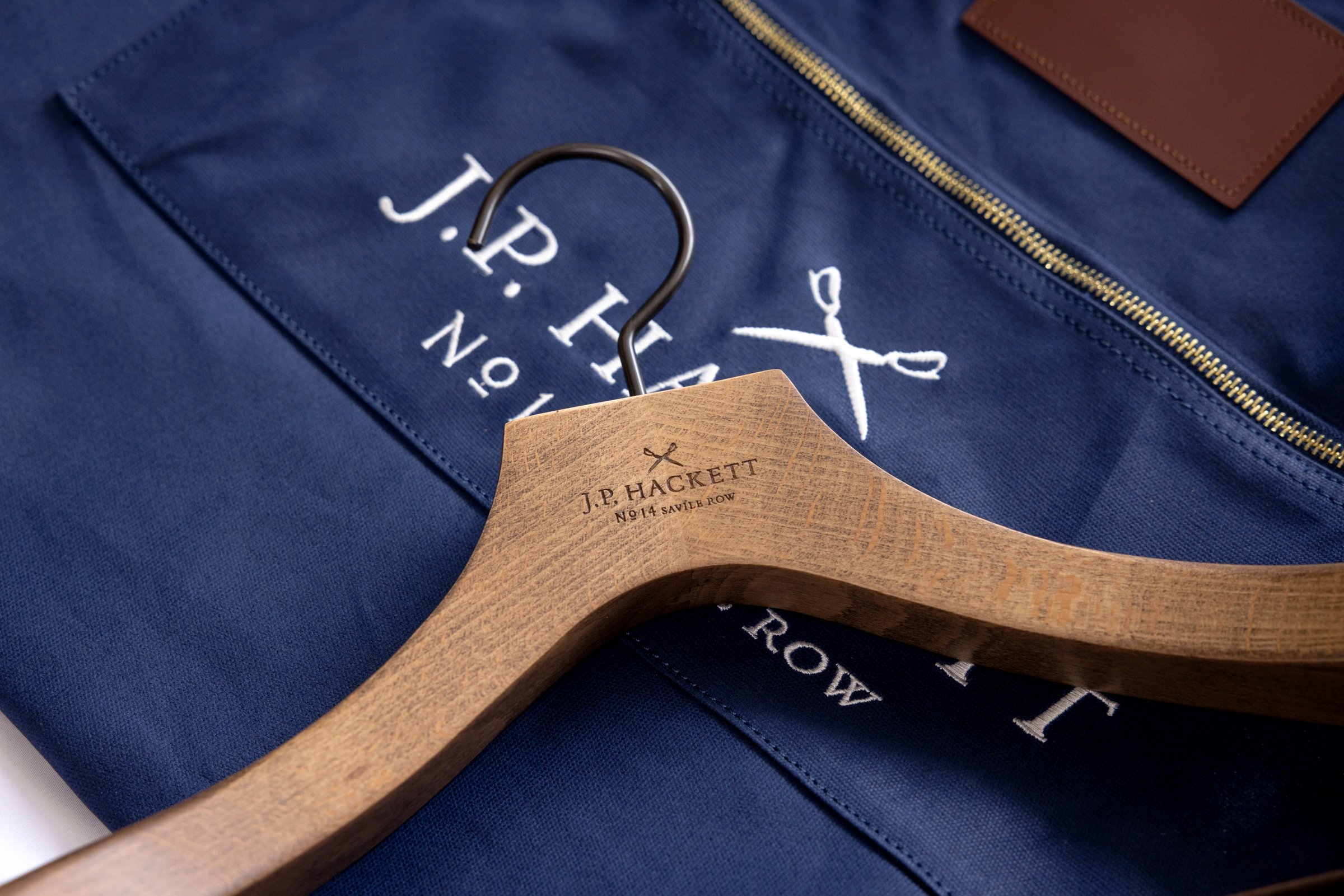 Custom wooden hanger on a branded garment bag