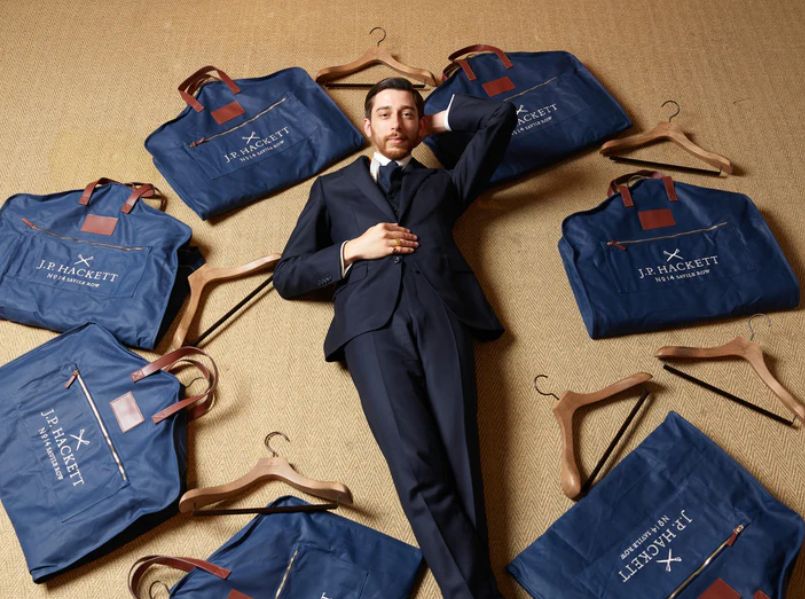 J.P. Hackett garment bags arranged with custom wooden hangers