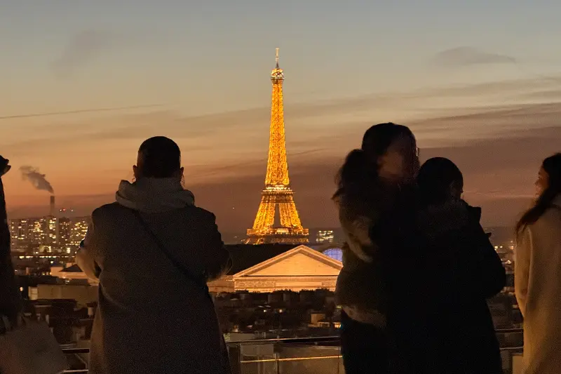 Couple admiring the Eiffel Tower at night